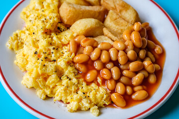 Scrambles Eggs With Baked Beans In Tomato Sauce And Thick Cut Fried Chips