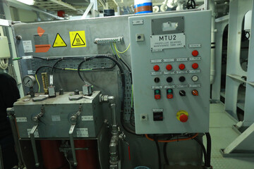 Cruise ship engine room interior with water tight doors electrical and diesel engines, water pipes, measuring instruments, diesel engines