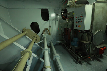 Cruise ship engine room interior with water tight doors electrical and diesel engines, water pipes, measuring instruments, diesel engines