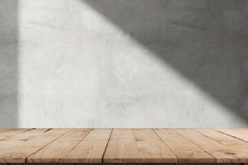 Empty of wood table top on abstract White concrete wall with  sunlight shadow reflected. For montage product design display mockup