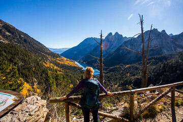 Young hiker woman in autumn in Aiguestortes and Sant Maurici National Park, Spain