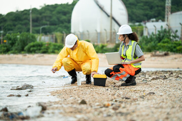 Environment scientist with team analysing waste water test results and collecting sample for research or inspection of the ecosystem and study of nature from an industrial factory into the sea