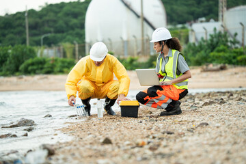 Environment scientist with team analysing waste water test results and collecting sample for research or inspection of the ecosystem and study of nature from an industrial factory into the sea