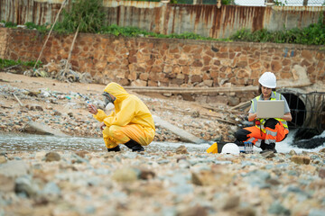 Environment scientist with team analysing waste water test results and collecting sample for research or inspection of the ecosystem and study of nature from an industrial factory into the sea