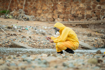 Environment scientist analysing waste water test results and collecting sample for research or...
