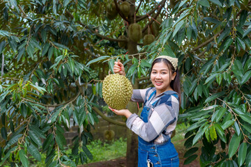 Durian farmer girl smiles sweetly to welcome Thai durian season