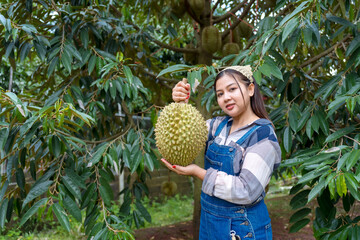 Durian farmer girl smiles sweetly to welcome Thai durian season