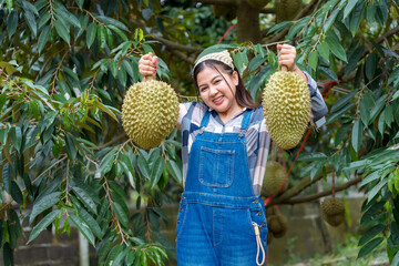 Durian farmer girl smiles sweetly to welcome Thai durian season