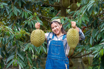Durian farmer girl smiles sweetly to welcome Thai durian season