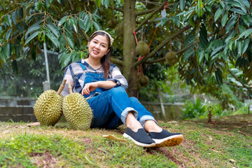 Durian farmer girl smiles sweetly to welcome Thai durian season
