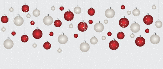 Christmas themed ornaments hanging on strings. There are alternating red and white baubles with polka dots on them. These are set against a background of snowfall.