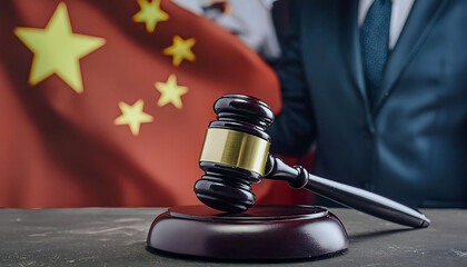 Judge’s Gavel on Table in Front of Chinese Flag, represents judicial authority and its influence on the Chinese legal system, highlighting the judge’s power in law enforcement