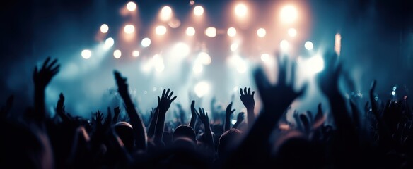 The vibrant crowd enjoying an electrifying concert with glowing lights.