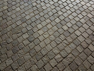Abstract background of square tiles on pavement at night