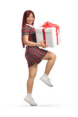 Asian female jumping and holding a present