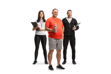 Mature man posing with personal fitness trainers