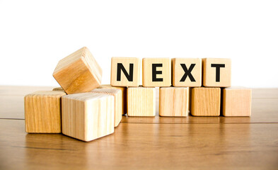 Next symbol. Concept word Next on beautiful wooden blocks. Beautiful wooden table white background....