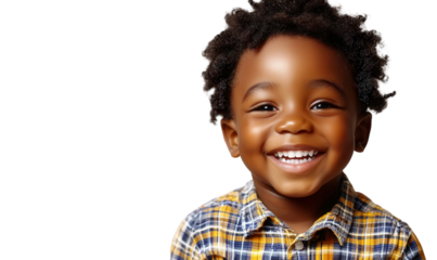 Happy young boy with curly hair smiles brightly in a colorful plaid shirt, showcasing joy and innocence in a vibrant portrait.image