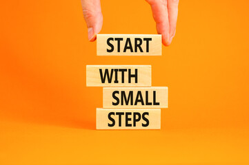 Start with small steps symbol. Concept words phrase Start with small steps on beautiful wooden...