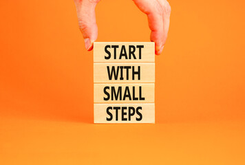 Start with small steps symbol. Concept words phrase Start with small steps on beautiful wooden...