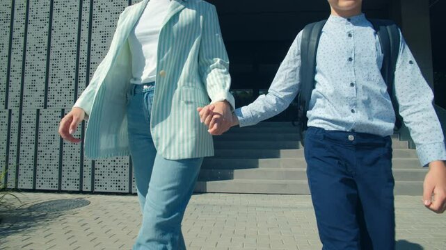 Mom and Son Walking Happily Outside Modern School Building
