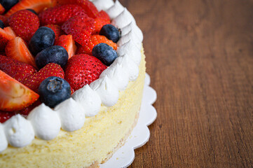 Delicious cheesecake with fresh strawberries and blueberries topping