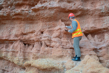 Geologist surveying mine,Explorers collect soil samples to look for minerals, A geologist is a...