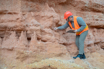 Geologist surveying mine,Explorers collect soil samples to look for minerals, A geologist is a...