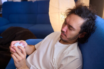 Close-up of an electric nail clipper in hand, modern personal care technology, highlighting compact...