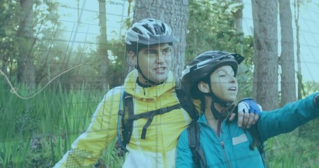 Couple standing forest trail, monitoring evolving fitness data overlay appearing after 1s - Powered by Adobe