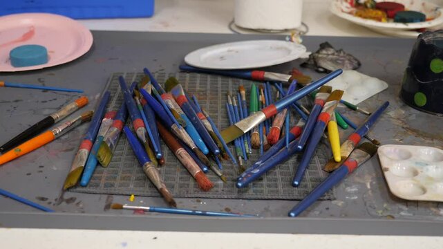 Active art studio with scattered brushes