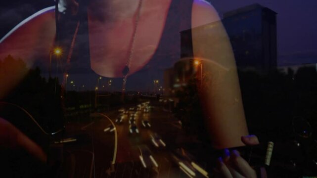 Music artist gripping guitar neck strumming chords singing through mic over highway lights for show