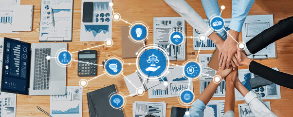 A professional team collaborates during a business ethics meeting, utilizing digital tools and...