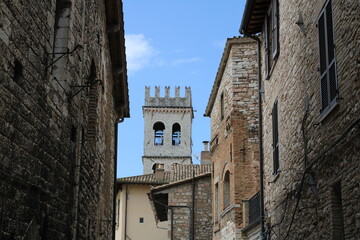 Streets in the old town of San Gimignano with tower in the background. Tuscany, Italy.