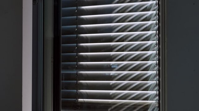 automated external blinds opening in a skyscraper office building