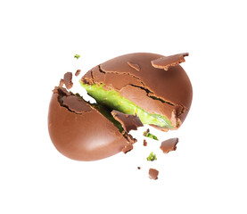 Cracked chocolate shell with green filling splashing out on a white background. Dubai chocolate is made with pistachio paste and kadayif