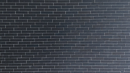 Black brick wall background, dark cement backdrop or wallpaper for interior design, rough texture of brick and cement construction.