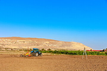 Soil leveling tractor working in the field