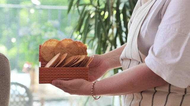 Bricelets thin, crispy Swiss wafers, traditionally served with coffee or raclette. Artisanal, patterned biscuits from western Switzerland, symbol of heritage and culinary craft.High quality 4k footage
