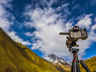Camera capturing serene mountain landscape during daytime in Kyrgyzstan