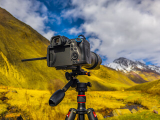 Digital camera on tripod capturing mountain Kyrgyzstan landscape
