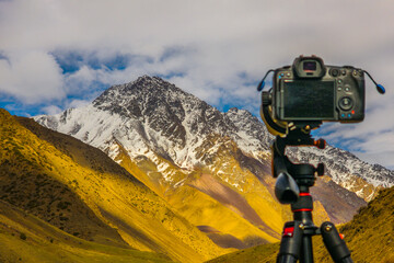 Camera capturing majestic Kyrgyzstan mountain range during daytime