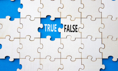 Fototapeta premium True or False symbol. Concept word True or False on wooden puzzle. Beautiful blue background. Business and True or False concept. Copy space