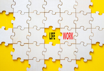 Life or Work symbol. Concept word Life or Work on wooden puzzle. Beautiful yellow background....