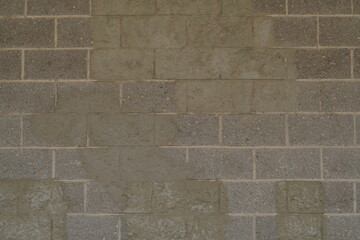 gray brick wall with streaks and green stone tint