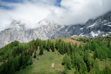 Fototapeta premium Misty mountain peaks and alpine forest landscape in the Austrian Alps