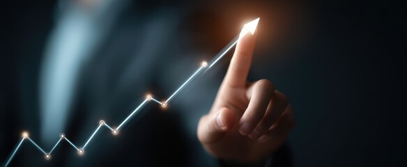 The business professional illustrating upward growth with a finger pointing at a rising chart