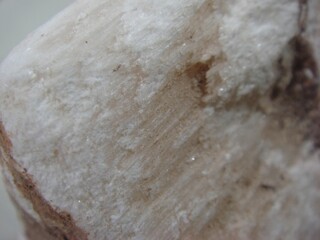 Block Cut of Korean Medicinal Gypsum on Neutral Cloth Background
