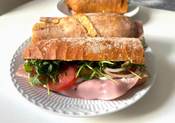 Close-up of baguette sandwich with italian martadella sausage