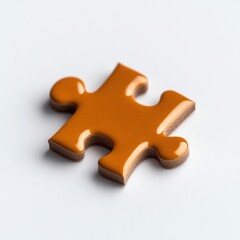 Fototapeta premium Close-up of a single orange puzzle piece on white background, symbolizing problem-solving and creativity.